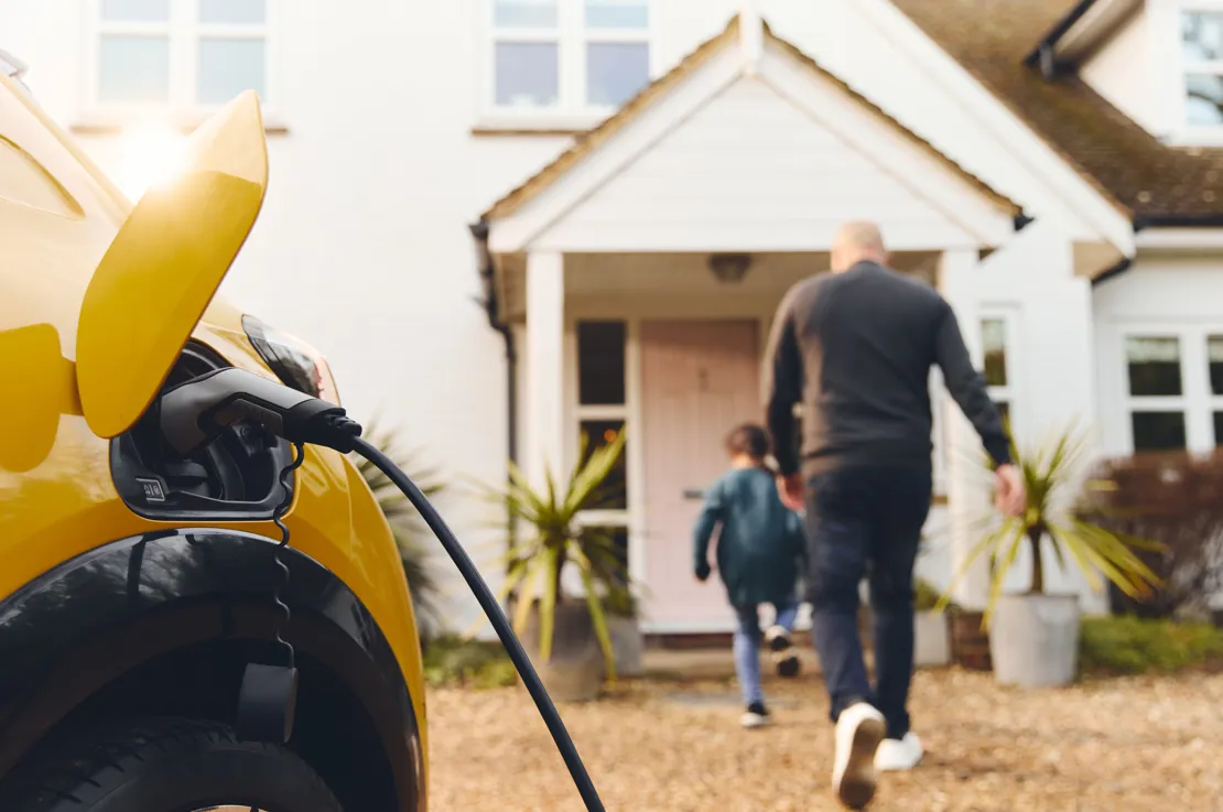 Family charging car at home
