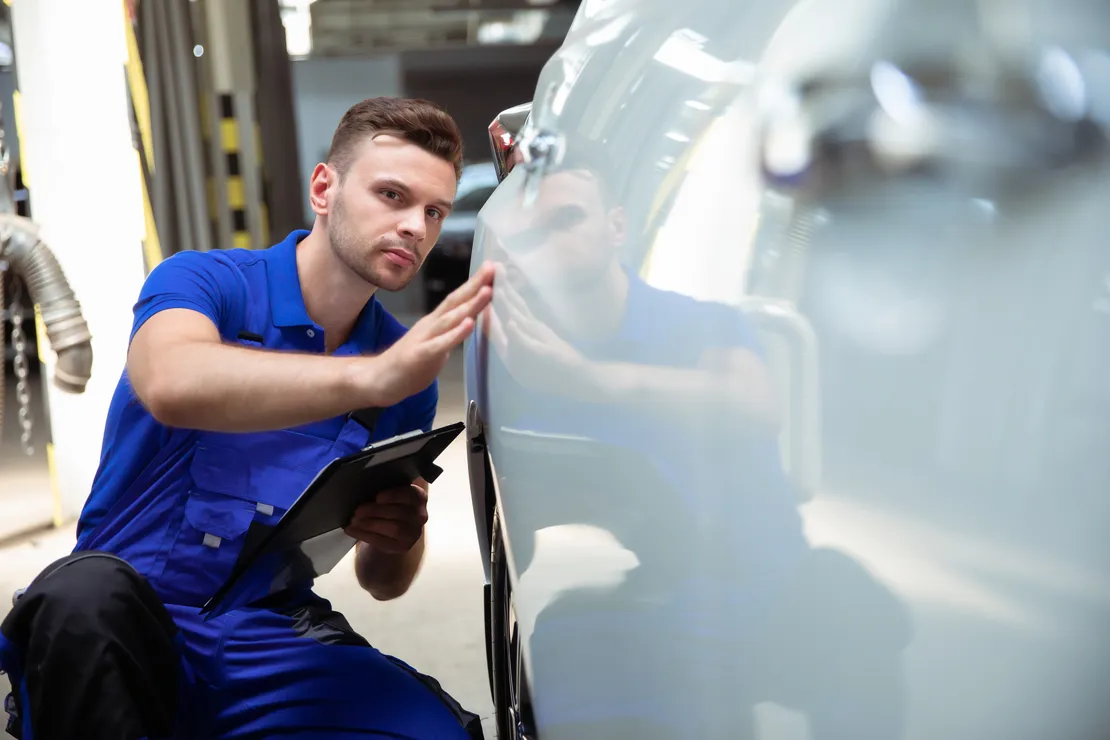Man inspecting car