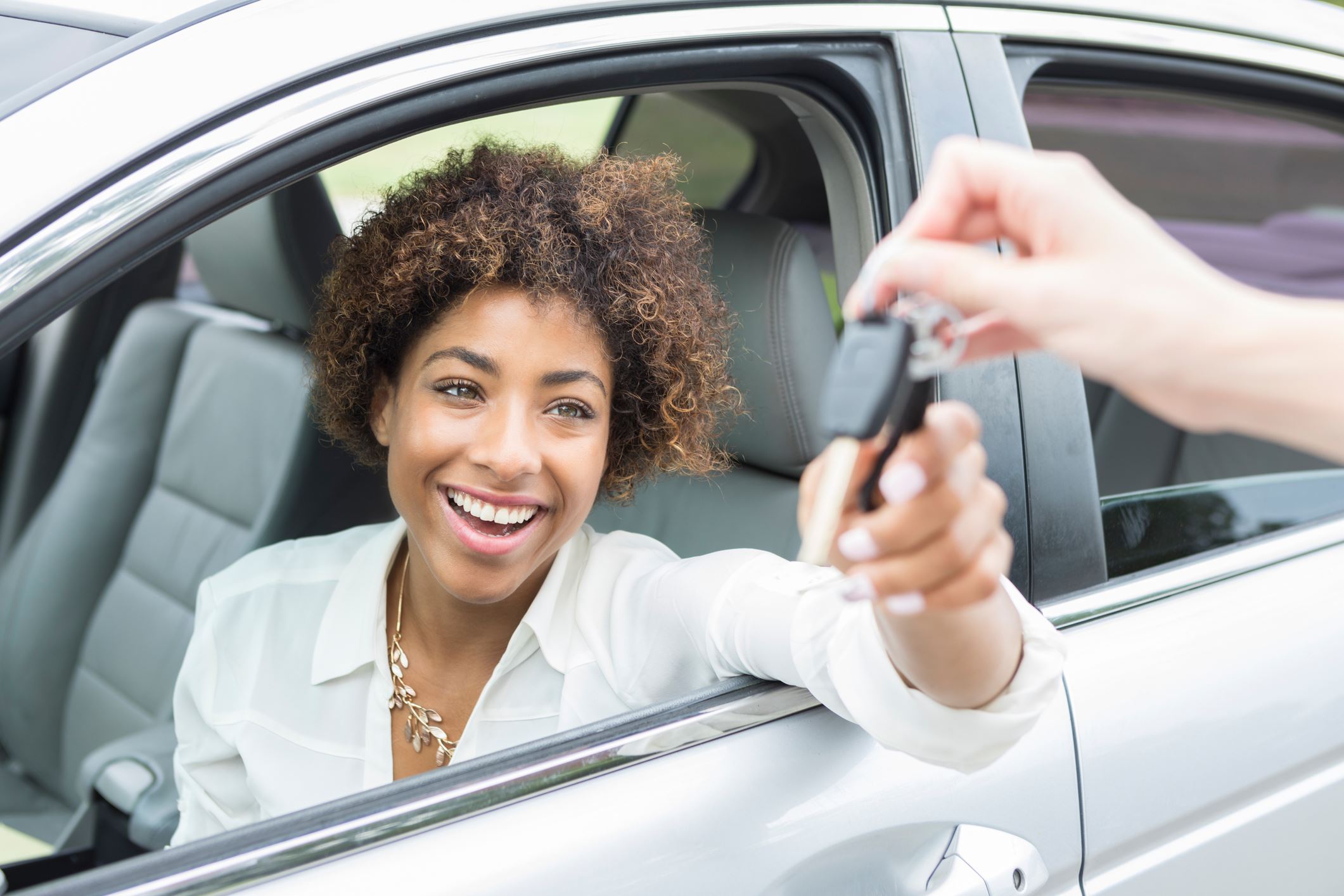 Woman getting keys to new car