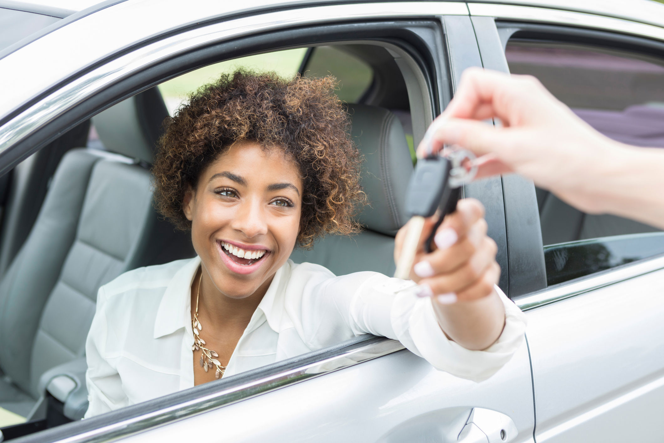 Woman getting keys to new car