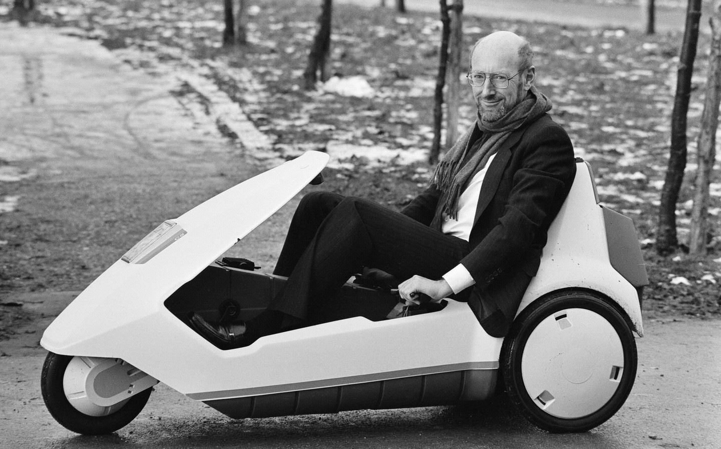 Sir Clive Sinclair sitting in the electric Sinclair C5