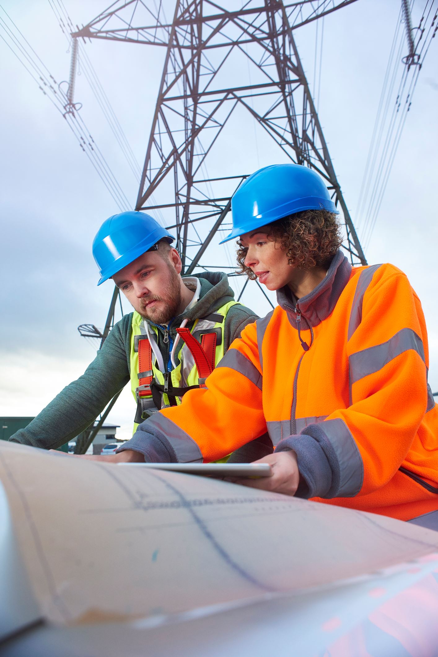 2 people looking at plans for electric work